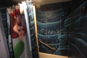 The shower is Ariel's grotto. I wonder if the designers realized this is a symbol of a womb in the movie, from which our adolescent must be "born" into adulthood?